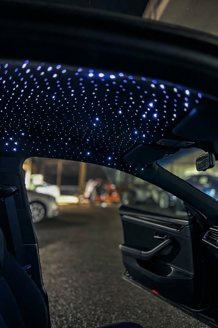 Blue and white starlight headliner in a sedan at night